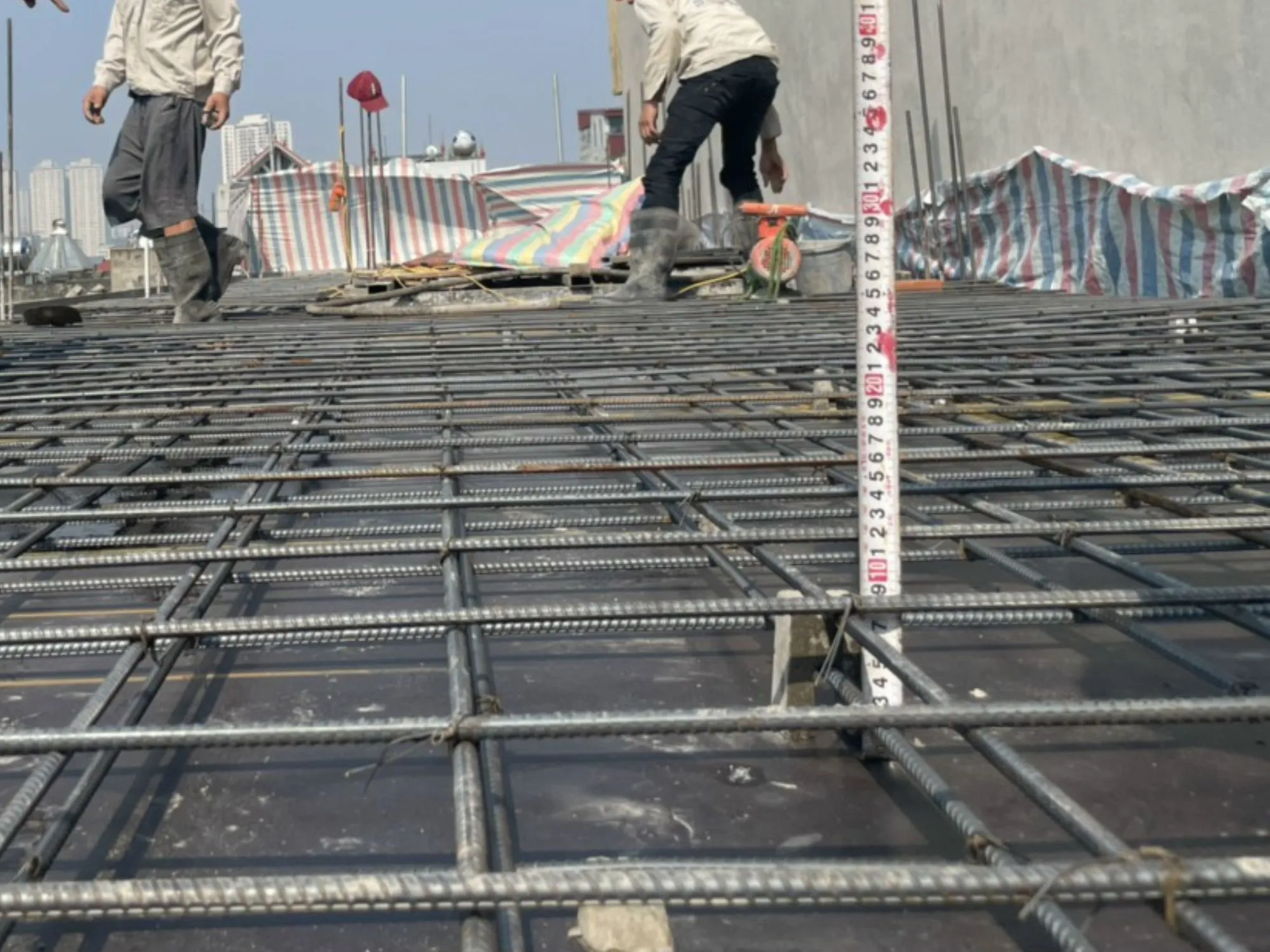 Công nhân đang thực hiện các bước kiểm tra cuối cùng trên hệ thống cốt thép trước khi đổ bê tông